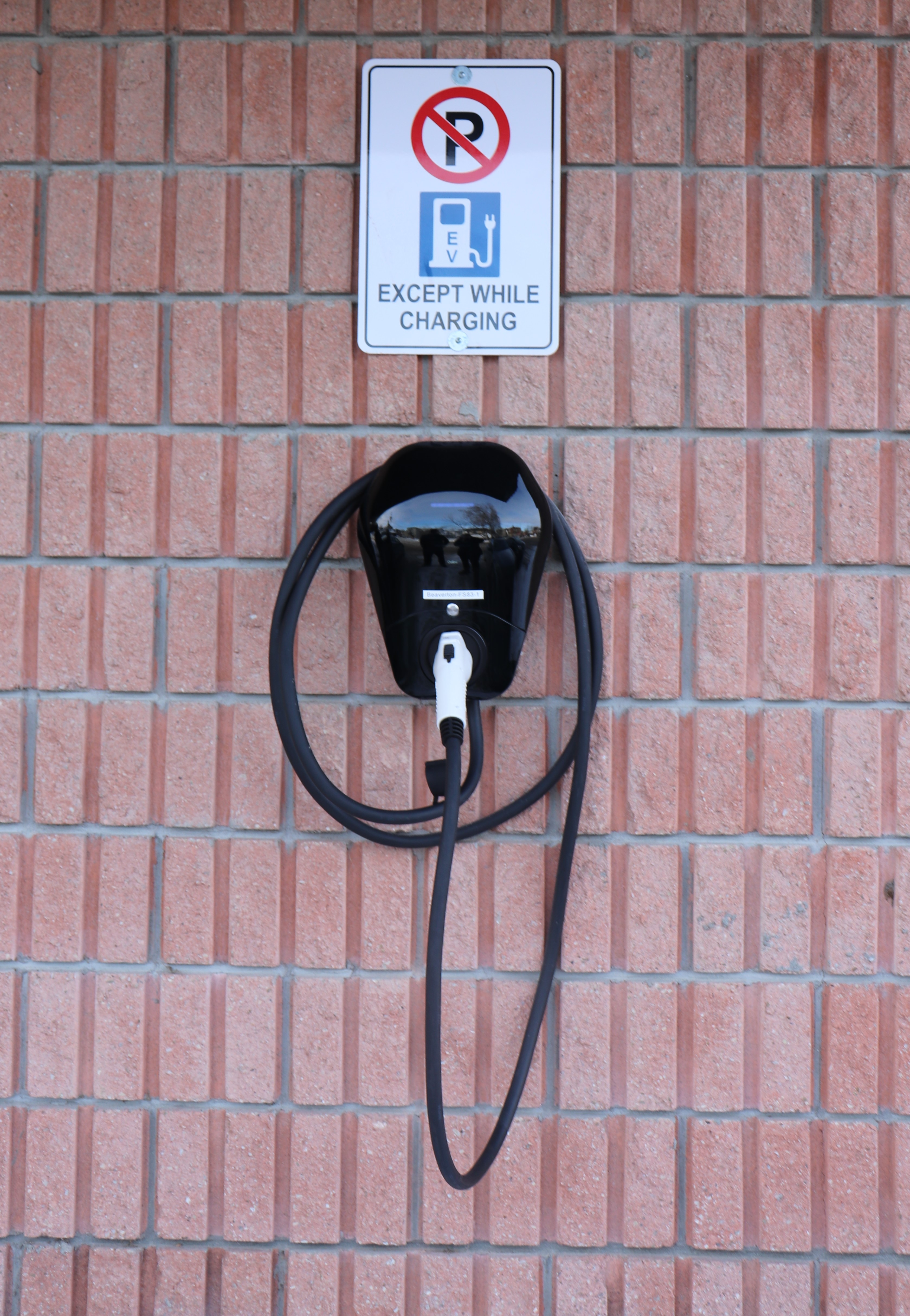 EV charging station on red brick wall