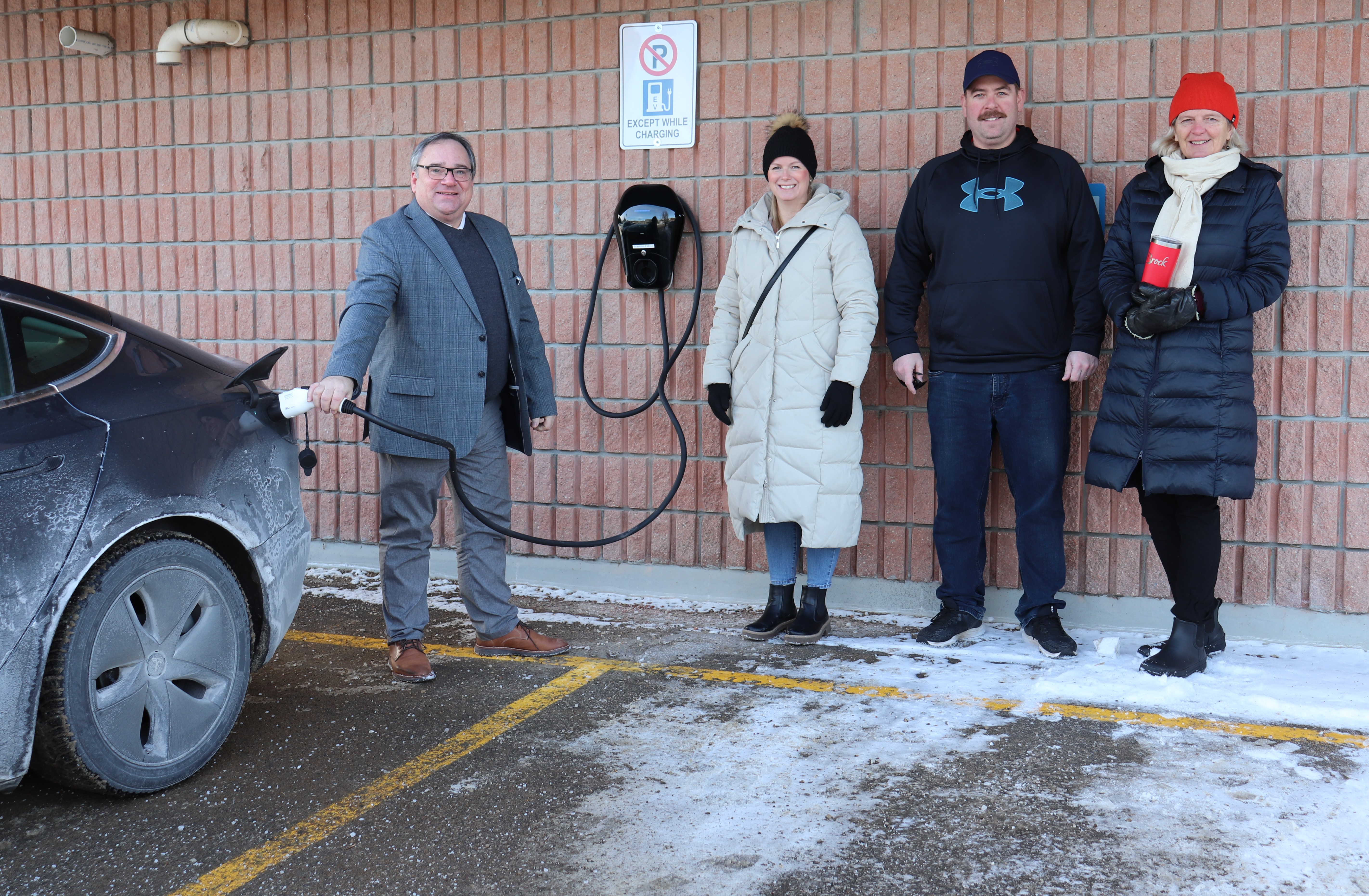 Mayor Walter Schummer, Councillor Doble, Regional Councillor Jubb, Councillor Pettingill standing in front of EV charging station at Beaverton Fire hall 