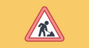 construction worker holding a yellow hard hat