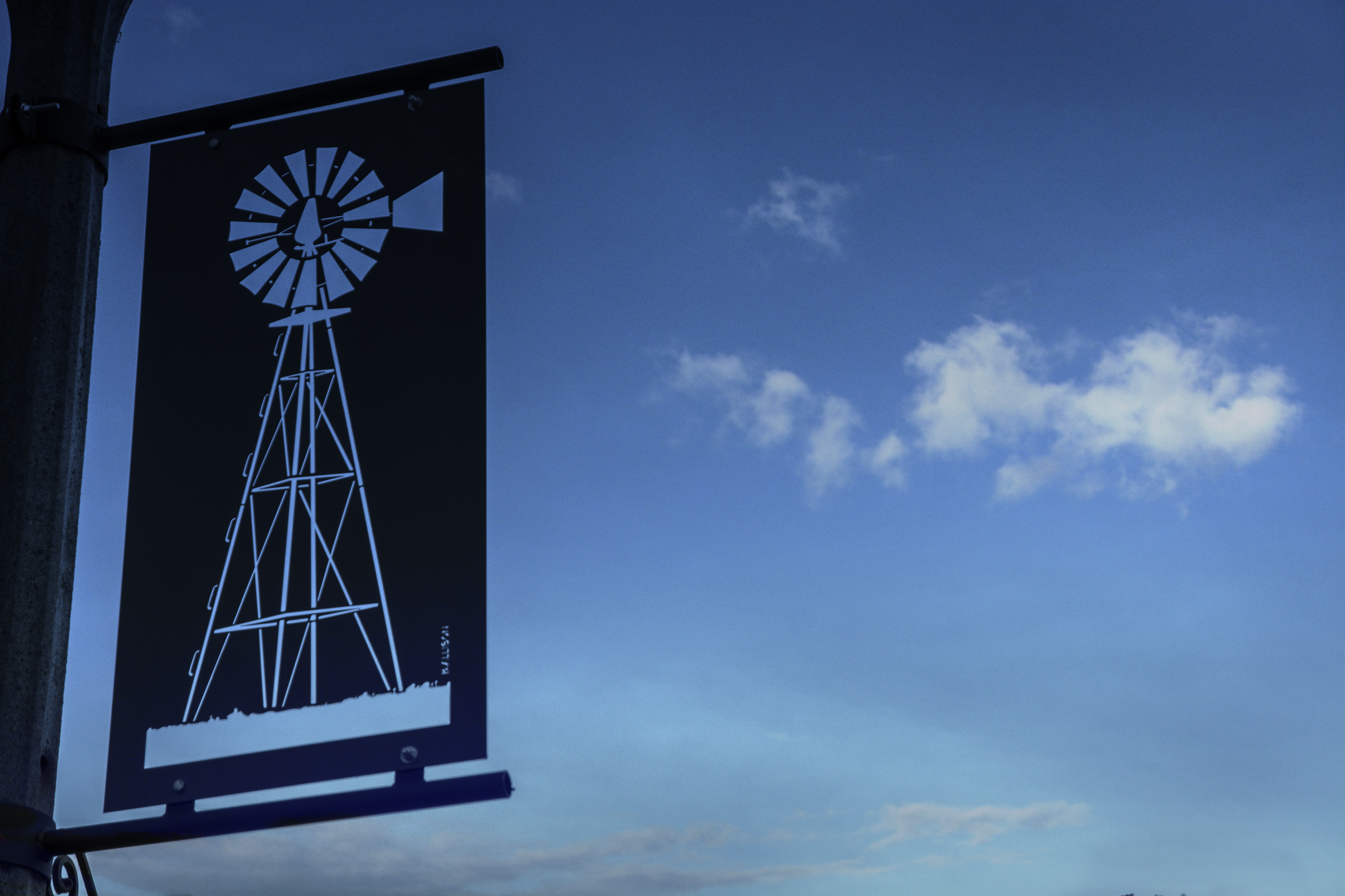 Artistic metal banner featuring a windmill